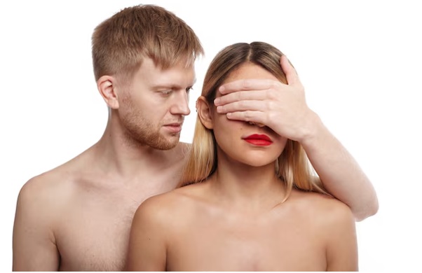 A man covering a woman's eyes lust