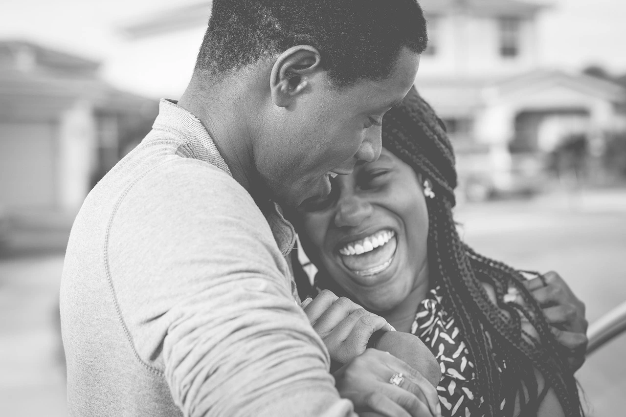 Happy black couple laughing, pationately in love, enjoying a romantic moment