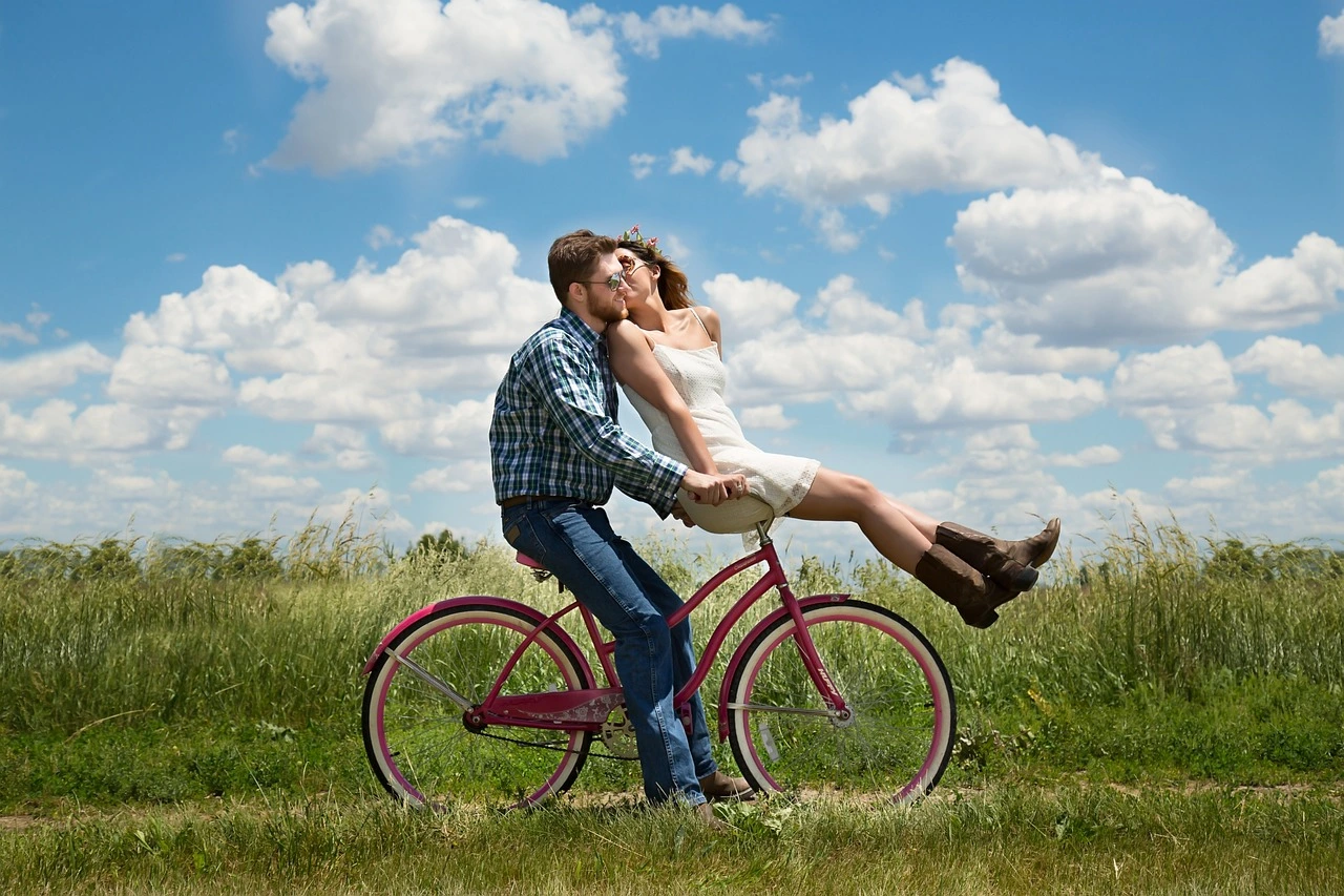 A happy romantic couple enjoying a bike ride on a sunny day, an adventure and love connection